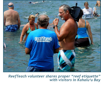 A ReefTeach volunteer shares proper reef etiquette with visitors in Kahaluu Bay